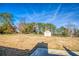 A large backyard is showcased, featuring a shed, mature trees, and an expansive lawn at 4541 Old Highway 138 Sw, Loganville, GA 30052