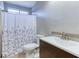 A bathroom with a granite countertop, shower with curtain, toilet, and modern faucet at 4541 Old Highway 138 Sw, Loganville, GA 30052