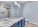 Bright bathroom featuring double sinks, modern fixtures, and a tiled walk-in shower at 4541 Old Highway 138 Sw, Loganville, GA 30052