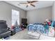 A cozy bedroom features neutral walls, carpet flooring, and a ceiling fan with a light at 4541 Old Highway 138 Sw, Loganville, GA 30052