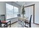 Bright breakfast nook featuring a table, three chairs, a large window, and a decorative Christmas tree at 4541 Old Highway 138 Sw, Loganville, GA 30052