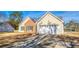 Ranch-style home with a wide driveway and a two-car garage at 4541 Old Highway 138 Sw, Loganville, GA 30052