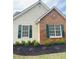 Charming exterior features a mix of brick and siding, complemented by green shutters and tasteful landscaping at 4541 Old Highway 138 Sw, Loganville, GA 30052