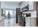 Well-equipped kitchen with modern appliances, granite countertops, and a view of the dining area at 4541 Old Highway 138 Sw, Loganville, GA 30052