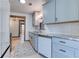 Well-lit kitchen features granite counters, white cabinets, and stainless appliances with a view into other living spaces at 4541 Old Highway 138 Sw, Loganville, GA 30052
