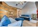 Cozy living room featuring vaulted ceilings, unique wood accent wall, and comfortable blue sofas at 4541 Old Highway 138 Sw, Loganville, GA 30052