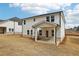 Another view of the backyard, showing the covered patio and white siding home at 291 Martin Spring Rd, Lawrenceville, GA 30045