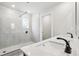 Bright bathroom featuring double sinks, white countertops, and a glass-enclosed shower at 291 Martin Spring Rd, Lawrenceville, GA 30045