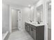 Elegant bathroom featuring double sinks, modern fixtures, and a separate shower room at 291 Martin Spring Rd, Lawrenceville, GA 30045