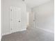 Neutral bedroom showcases plush carpet and a door leading to another room at 291 Martin Spring Rd, Lawrenceville, GA 30045