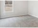 Bright bedroom features a window, neutral paint, and plush carpeting at 291 Martin Spring Rd, Lawrenceville, GA 30045