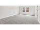 Bright bedroom features neutral paint and carpet with a sunny window at 291 Martin Spring Rd, Lawrenceville, GA 30045