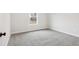 Bright bedroom features neutral paint and carpet with a sunny window at 291 Martin Spring Rd, Lawrenceville, GA 30045