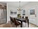 Dining area featuring a table, six chairs, and stainless steel refrigerator at 291 Martin Spring Rd, Lawrenceville, GA 30045