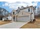 Charming two-story home featuring a two-car garage, white brick and siding, and a covered porch at 291 Martin Spring Rd, Lawrenceville, GA 30045