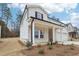 Attractive two-story home featuring a covered porch with brick and white siding in a suburban neighborhood at 291 Martin Spring Rd, Lawrenceville, GA 30045