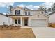 Beautiful two-story home with a two-car garage, covered porch and a combination of brick and siding at 291 Martin Spring Rd, Lawrenceville, GA 30045