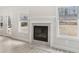 Close-up of a fireplace in a living area with wood-look floors and large windows at 291 Martin Spring Rd, Lawrenceville, GA 30045