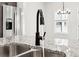 Close-up of the kitchen sink with granite countertops and stainless steel appliances at 291 Martin Spring Rd, Lawrenceville, GA 30045