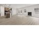 Spacious open-concept living area featuring wood-look floors, a fireplace, and seamless flow to the kitchen at 291 Martin Spring Rd, Lawrenceville, GA 30045