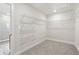Walk-in closet with shelving on a carpeted floor and ample storage space at 291 Martin Spring Rd, Lawrenceville, GA 30045