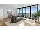 Bright living room featuring large windows with city views, modern furnishings, and neutral tones at 2425 Peachtree Ne Rd # 1106, Atlanta, GA 30305