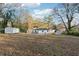 Home's extensive backyard features multiple storage sheds and mature trees at 1751 Nathan Ln, Austell, GA 30168