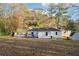 The back of the house shows an open, grassy backyard with a deck and storage shed at 1751 Nathan Ln, Austell, GA 30168