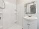 Bathroom featuring a white tile shower and a modern vanity at 1751 Nathan Ln, Austell, GA 30168