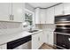 Kitchen showcasing white cabinets, stainless steel appliances, and modern design at 1751 Nathan Ln, Austell, GA 30168