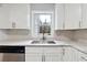 Kitchen showcasing white cabinets, stainless steel appliances, and granite countertops at 1751 Nathan Ln, Austell, GA 30168