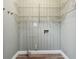 Laundry room featuring wood floors, gray beadboard paneling and wire shelving at 1751 Nathan Ln, Austell, GA 30168