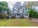 Cozy ranch home with a grassy yard and trees at 3147 Canary Ct, Decatur, GA 30032