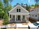 Charming single-Gathering home with a classic design, featuring a covered front porch and board and batten siding at 11792 Serenbe Ln, Chattahoochee Hills, GA 30268