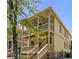 Charming two-story home featuring a double balcony, yellow siding, and inviting brick stairs at 110 Hogue St, Atlanta, GA 30312