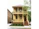 Inviting two-story yellow home with double balconies, brick foundation, and well-kept landscaping at 110 Hogue St, Atlanta, GA 30312