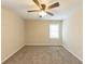 Bright bedroom featuring a ceiling fan and large window at 1360 Lockhaven Sw Cir, Atlanta, GA 30311