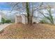 Side view of tan house with tree and driveway at 1360 Lockhaven Sw Cir, Atlanta, GA 30311