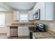 Modern kitchen with granite countertops and stainless steel appliances at 1360 Lockhaven Sw Cir, Atlanta, GA 30311