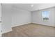 Bright, carpeted bedroom with a window offering a view of the outdoors at 819 Major Oak Ct, Villa Rica, GA 30180
