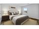 Serene bedroom with a tufted headboard bed, neutral tones, and natural light from a window at 819 Major Oak Ct, Villa Rica, GA 30180