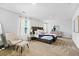 Spacious bedroom features a large bed, neutral walls, and carpet flooring at 819 Major Oak Ct, Villa Rica, GA 30180