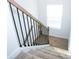 Carpeted staircase features black metal spindles and light wood handrail at 819 Major Oak Ct, Villa Rica, GA 30180