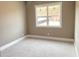 Bedroom with neutral walls, carpet, and a large window for natural light at 3345 Hillshire Dr, Cumming, GA 30028