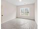 Bright bedroom with neutral walls and carpet, featuring a large window at 3340 Hillshire Dr, Cumming, GA 30028