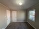 Spacious bedroom with neutral walls, carpet, and exterior view at 721 Yale Sw Pl, Atlanta, GA 30315