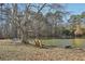 Serene pond-side setting with a bench and mature trees at 2051 Sheffield Rd, Conyers, GA 30012