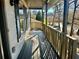 Wooden balcony with railing overlooking backyard and street at 627 Huntington Nw Way, Lilburn, GA 30047