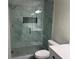 Modern bathroom with glass shower, quartz countertop, and gray tile at 627 Huntington Nw Way, Lilburn, GA 30047
