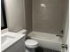 Modern bathroom with gray tile and a white vanity at 627 Huntington Nw Way, Lilburn, GA 30047